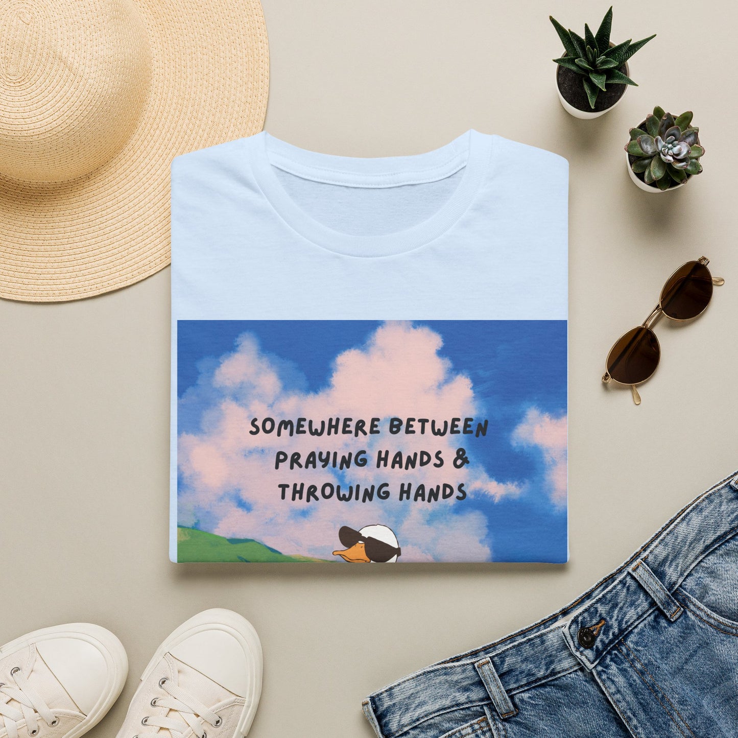T‑Shirt — "Somewhere Between Praying Hands & Throwing Hands" Cute Goose Tee